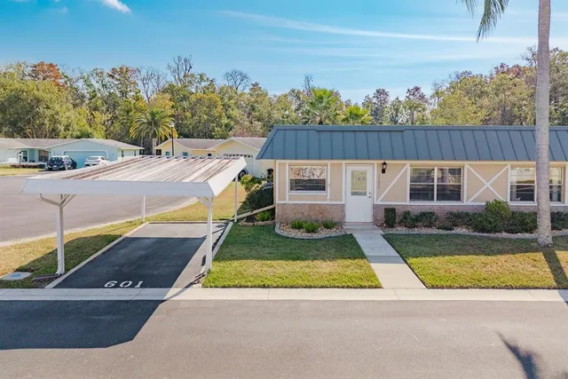 a view of backyard with swimming pool and outdoor seating