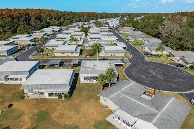 an aerial view of a residential houses with outdoor space