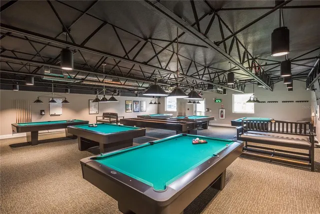 a room with pool table and a projector