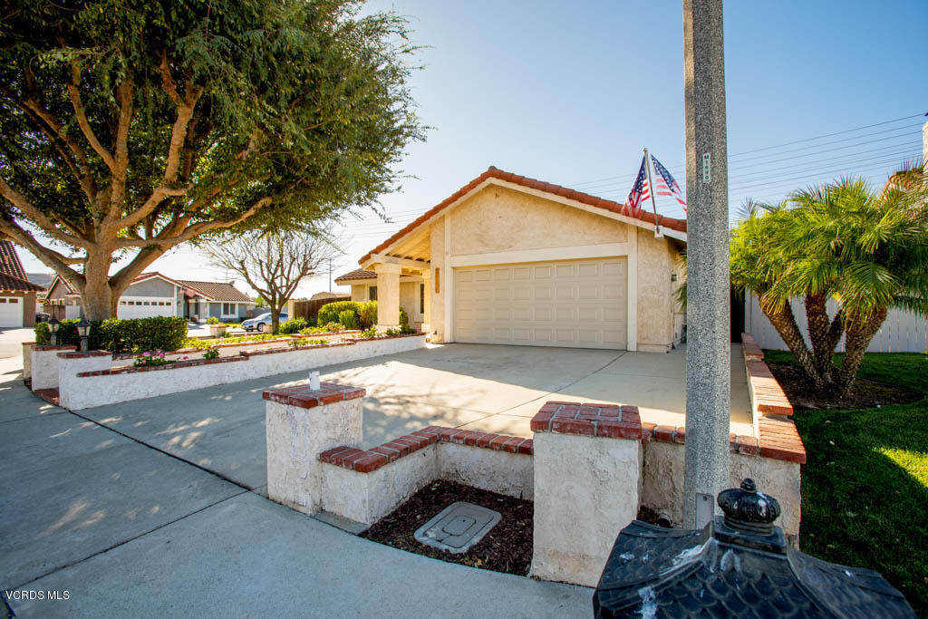 4713 Avedon Road Moorpark, CA 93021 - Photo 3 of 33 a view of a white house with a yard and tree s
