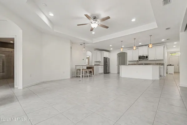 a kitchen with stainless steel appliances granite countertop a stove top oven a sink a refrigerator and a granite counter tops