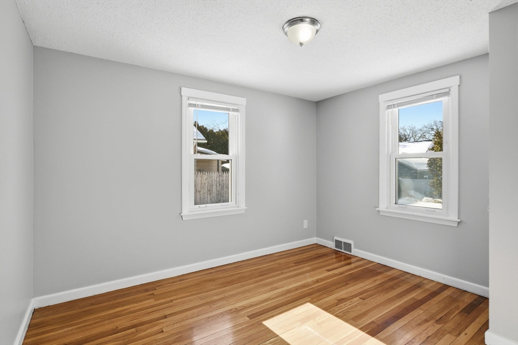 118 Pilgrim Road Springfield, MA 01118 - Photo 15 of 24 a view of empty room with wooden floor and fan