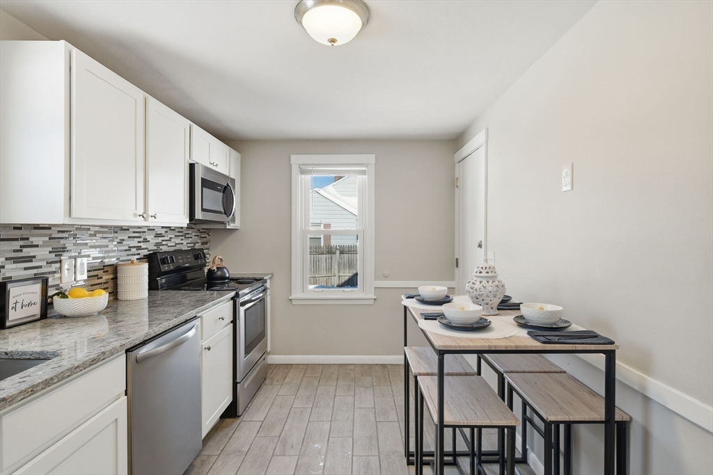 118 Pilgrim Road Springfield, MA 01118 - Photo 3 of 24 a kitchen with a sink cabinets and window