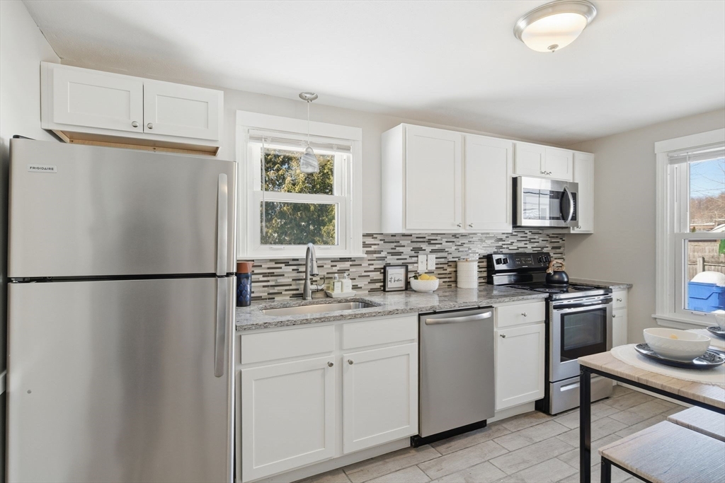 118 Pilgrim Road Springfield, MA 01118 - Photo 5 of 24 a white refrigerator freezer sitting inside of a kitchen