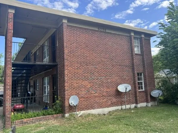a front view of a house with garden space and patio