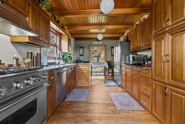 a kitchen with a table chairs sink and cabinets