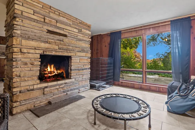 a living room with furniture and a floor to ceiling window