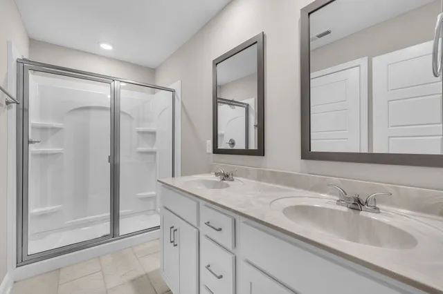 a bathroom with a shower sink and mirror