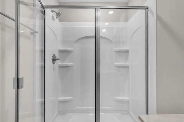 a bathroom that has a glass shower door
