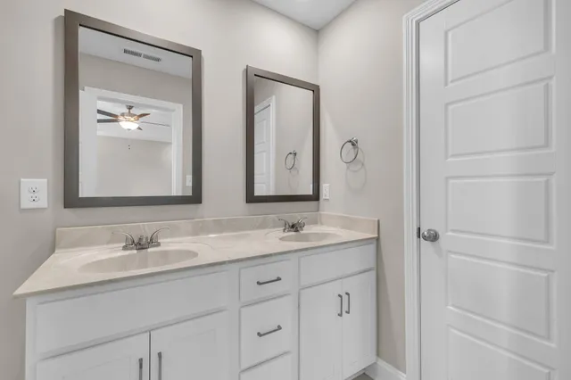 a bathroom with 2 sink and a mirror