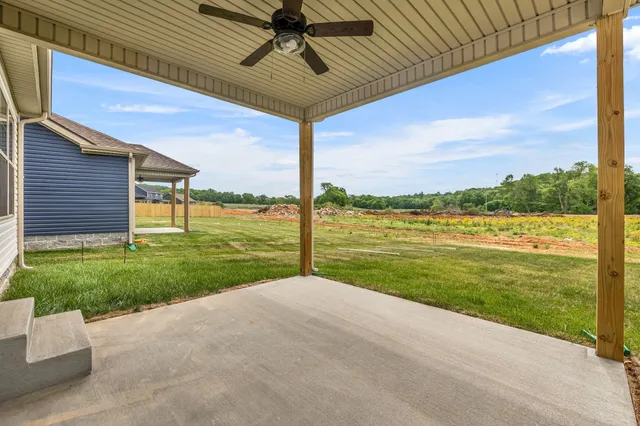 a view of a house with yard and a patio