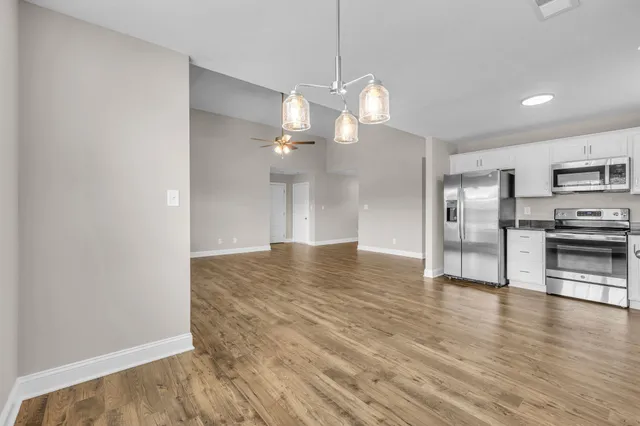 a view of a kitchen with a stove cabinets and wooden floor