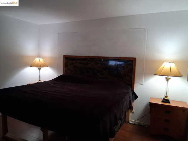 a bedroom with a bed and a lamp