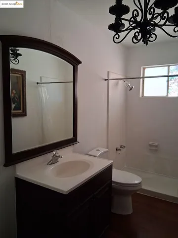 a bathroom with a sink mirror and toilet