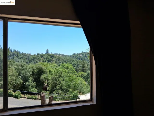 a view of a balcony with a yard