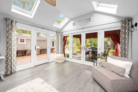 a spacious bedroom with a large window and a couch