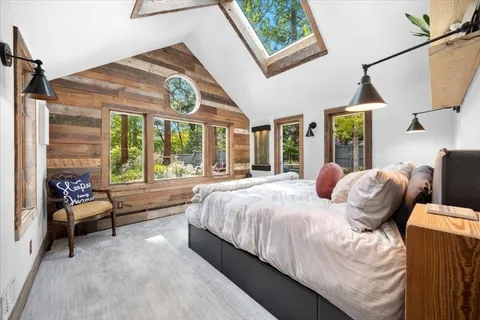 a bed sitting in a bedroom next to a window