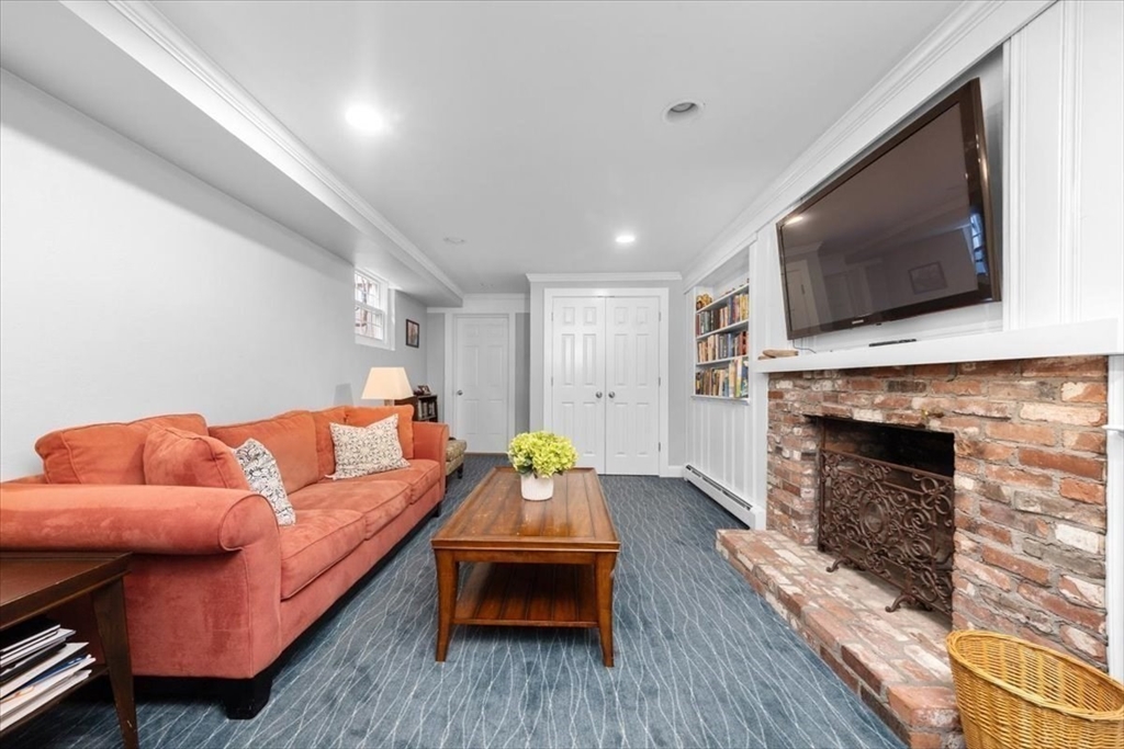 3 Howland Lane Hingham, MA 02043 - Photo 22 of 42 a living room with furniture a flat screen tv and a fireplace