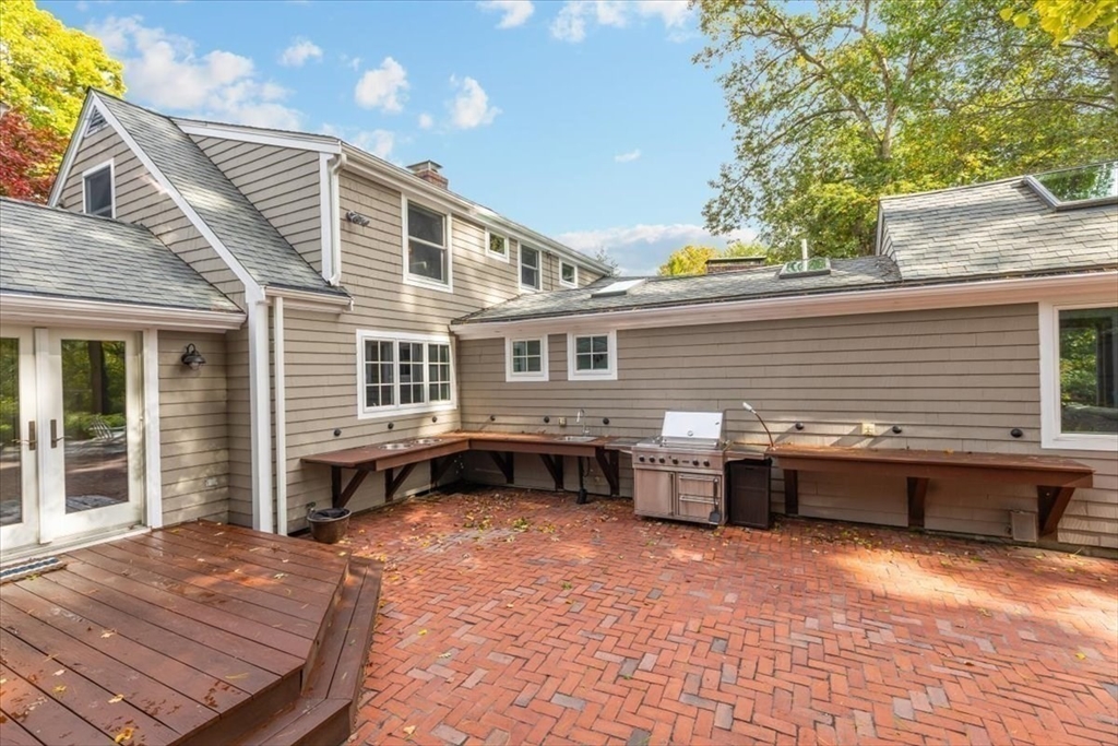 3 Howland Lane Hingham, MA 02043 - Photo 23 of 42 a backyard of a house with barbeque oven and outdoor seating