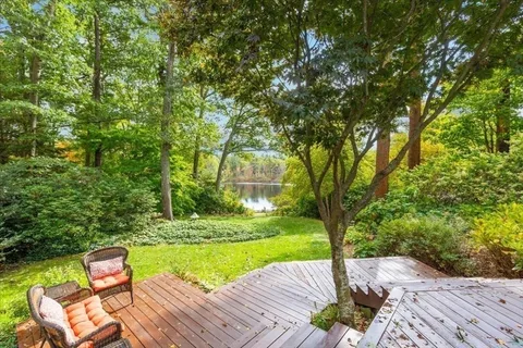 a view of yard with seating area and trees around
