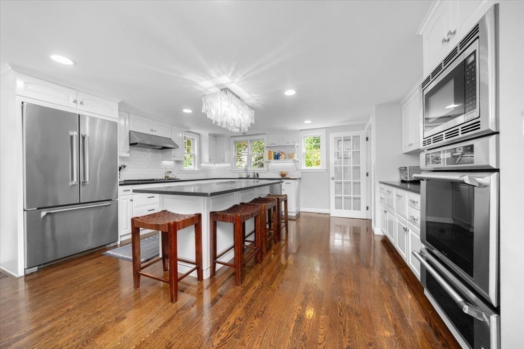 3 Howland Lane Hingham, MA 02043 - Photo 3 of 42 a kitchen with stainless steel appliances granite countertop a refrigerator a stove top oven a sink dishwasher and white cabinets with wooden floor