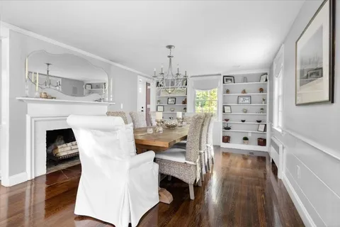 a living room with furniture a fireplace and wooden floor