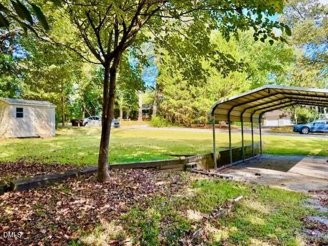 a view of a house with backyard and trees