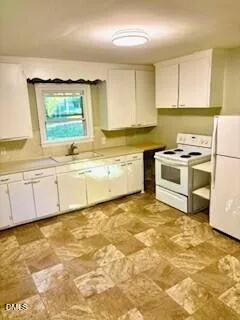 a kitchen with a stove a sink and a refrigerator