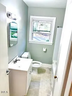 a bathroom with a sink toilet and window