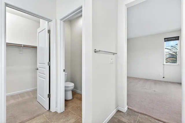 a bathroom with a granite countertop toilet and a shower