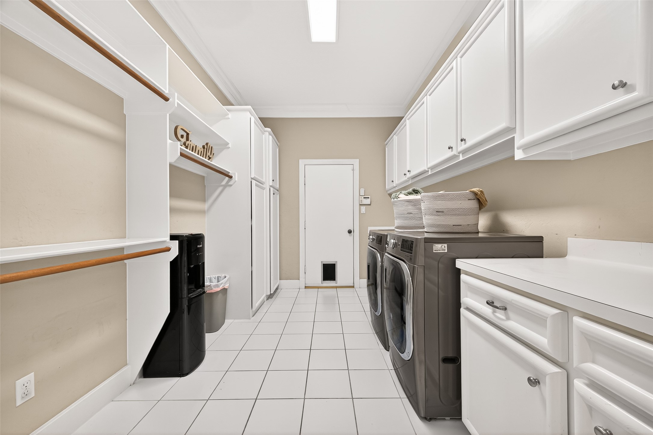 22 Stonegate Park Court Spring, TX 77379 - Photo 19 of 49 View of the oversized utility room with tons of storage, counter space and hanging rods.