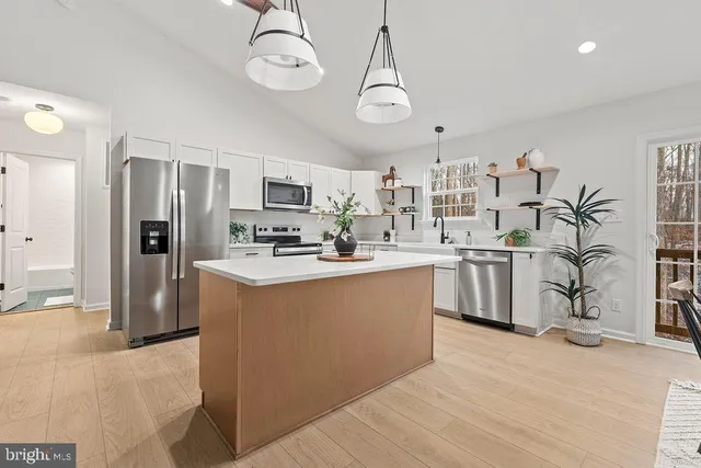 a kitchen with cabinets a sink and appliances