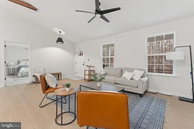 a living room with furniture and kitchen view