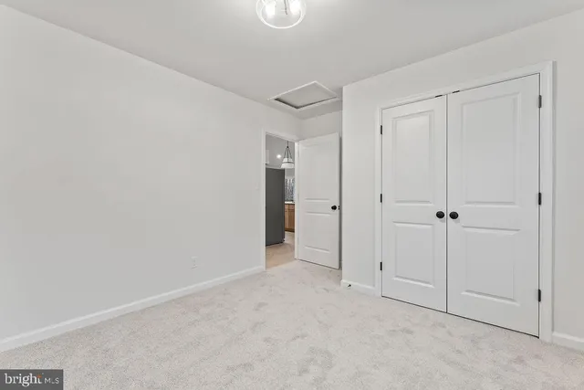 a bedroom with a bed dresser and a window