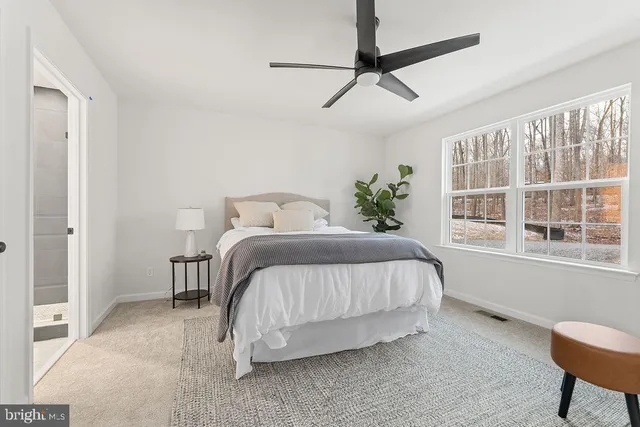 a bedroom with a bed and a chair