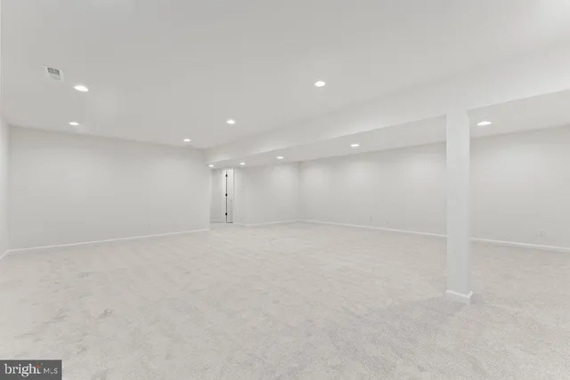 a front view of a house with a garden and yard