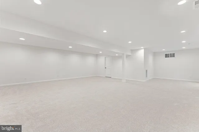 a front view of a house with a garden and tree