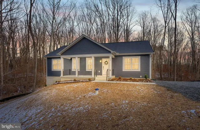 a view of a house with a snow in the yard