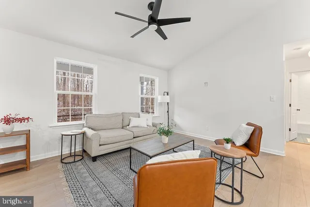 a living room with furniture a rug and a window
