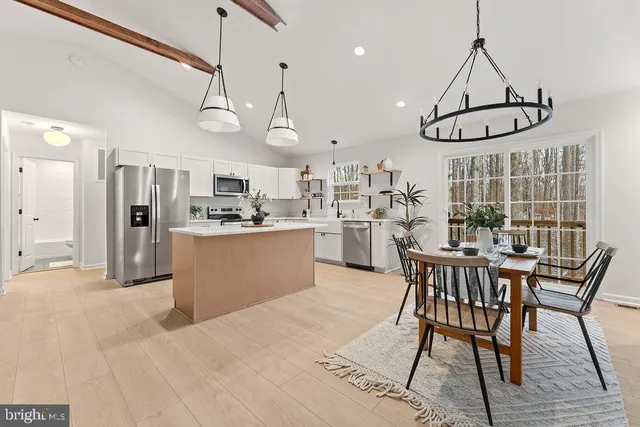 a dining room with furniture window and wooden floor