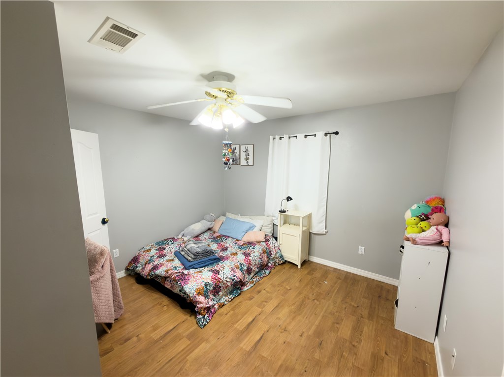 164 Park Road Russellville, AR 72802 - Photo 7 of 35 Bedroom featuring wood-finish flooring, light gray wall paint, and a ceiling fan with integrated lighting