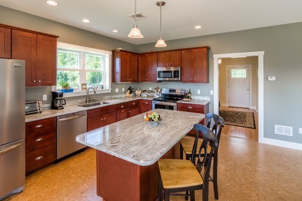 135 Marion Road Middleboro, MA 02346 - Photo 3 of 30 a kitchen with a stove a sink a dining table and chairs