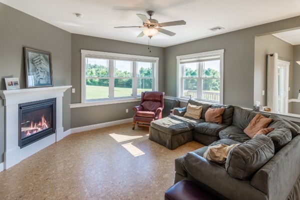 135 Marion Road Middleboro, MA 02346 - Photo 7 of 30 a living room with furniture a fireplace and a large window