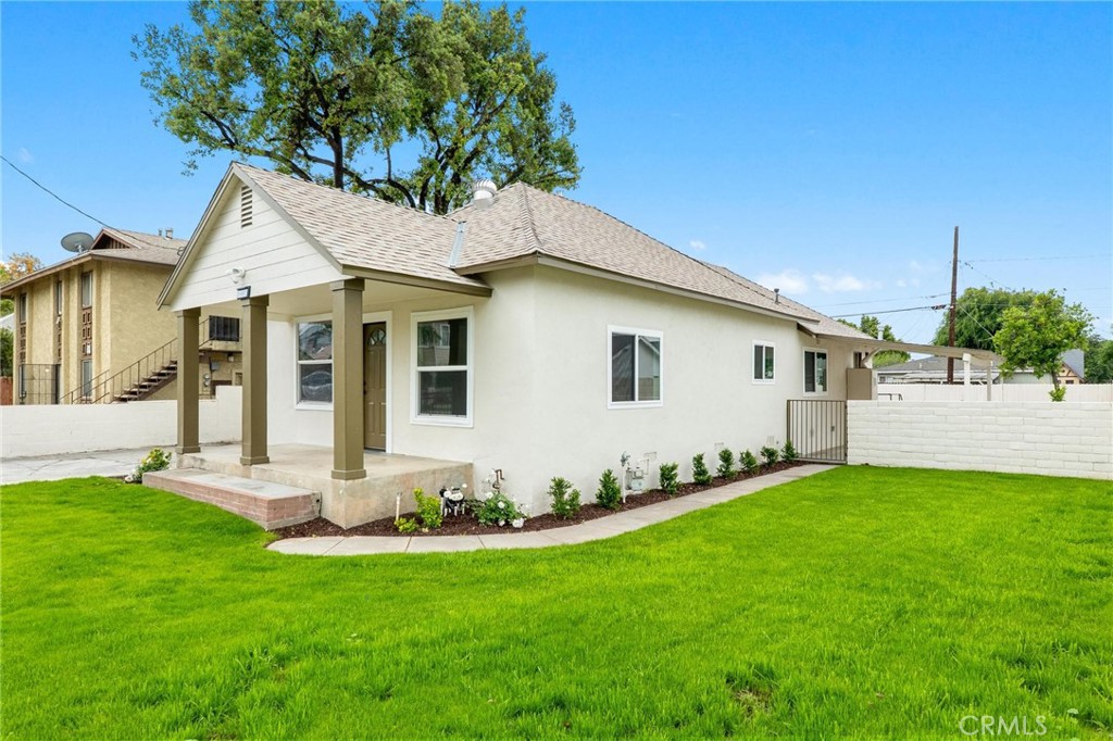 3882 Taft Street Riverside, CA 92503 - Photo 2 of 37 a front view of a house with a yard and garage