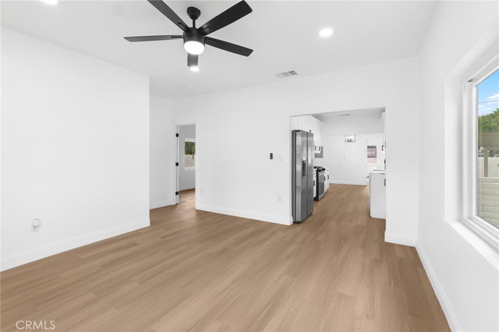 3882 Taft Street Riverside, CA 92503 - Photo 24 of 37 a view of a hallway with wooden floor and a ceiling fan