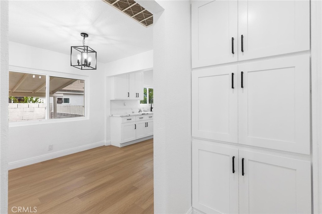 3882 Taft Street Riverside, CA 92503 - Photo 25 of 37 a view of a kitchen with wooden floor and windows