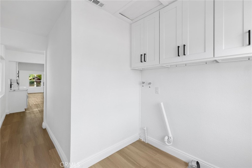 3882 Taft Street Riverside, CA 92503 - Photo 27 of 37 a view of walk in closet with wooden floor