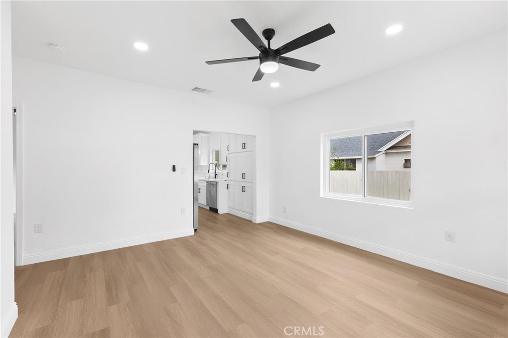 3882 Taft Street Riverside, CA 92503 - Photo 8 of 37 an empty room with wooden floor and windows