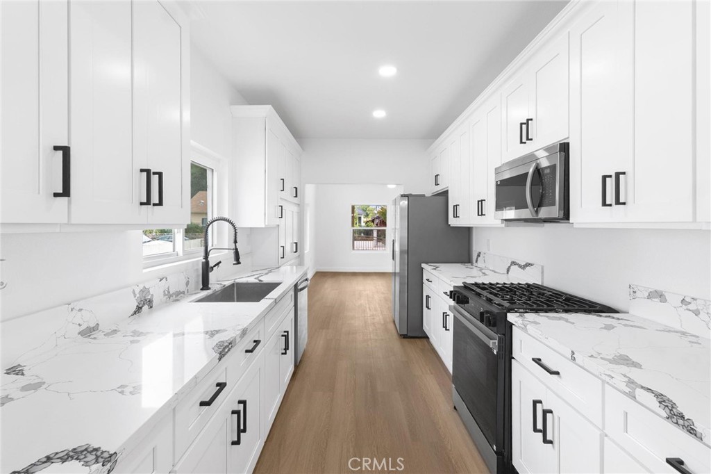 3882 Taft Street Riverside, CA 92503 - Photo 9 of 37 a kitchen with stainless steel appliances a sink stove and cabinets