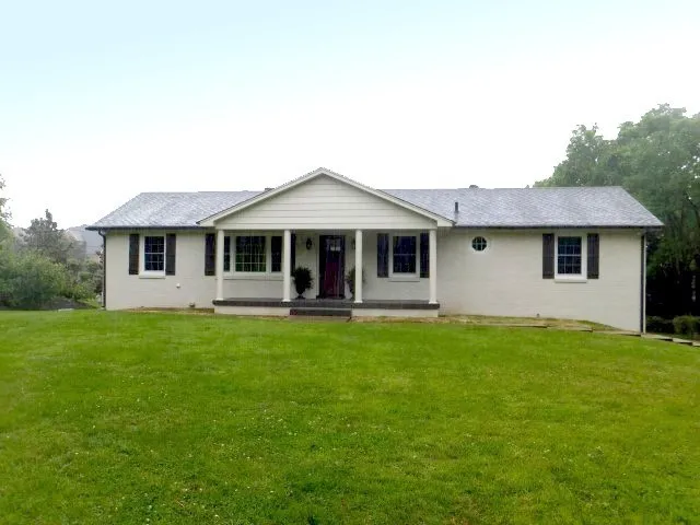a front view of a house with a garden